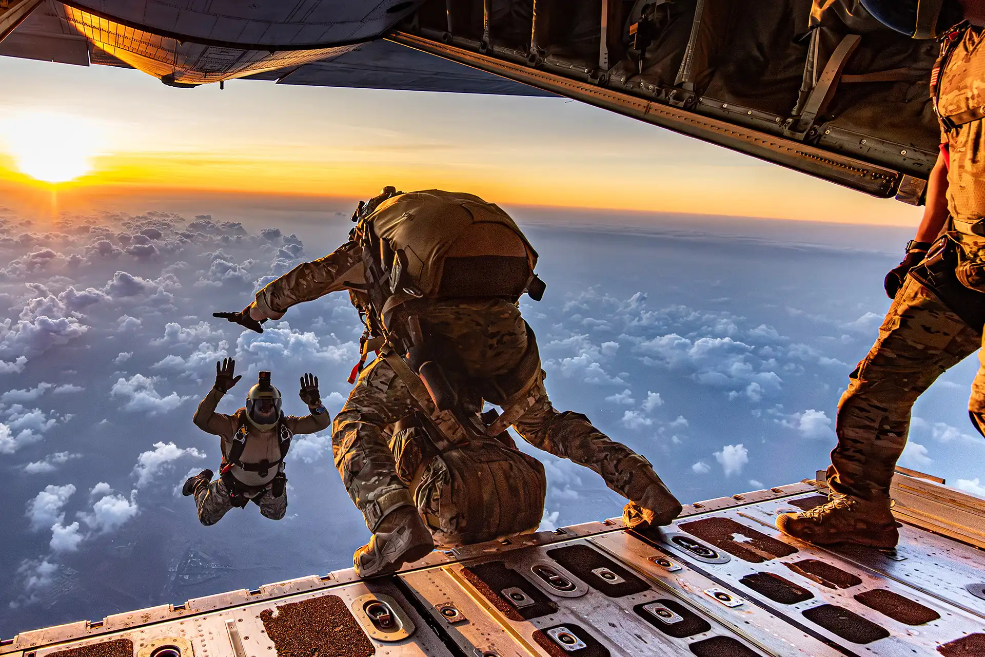 Special operators jumping from the ramp of a C-130 above the clouds